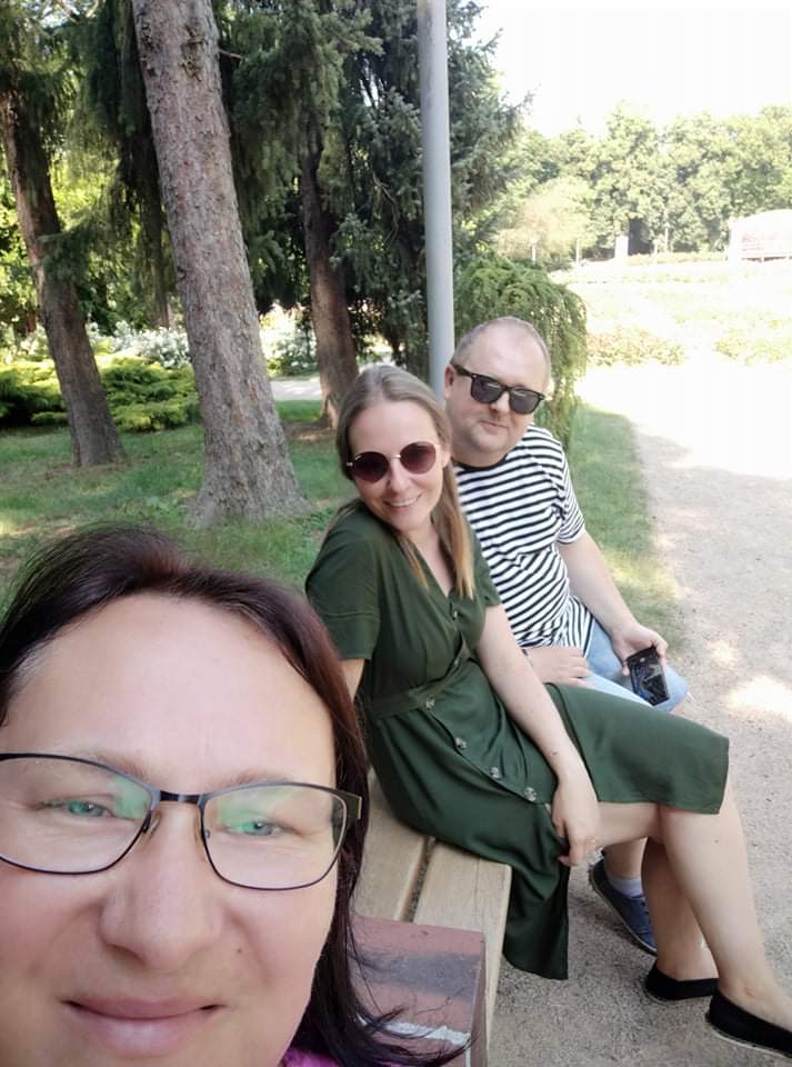 Dwie kobiety i mężczyzna na ławce.