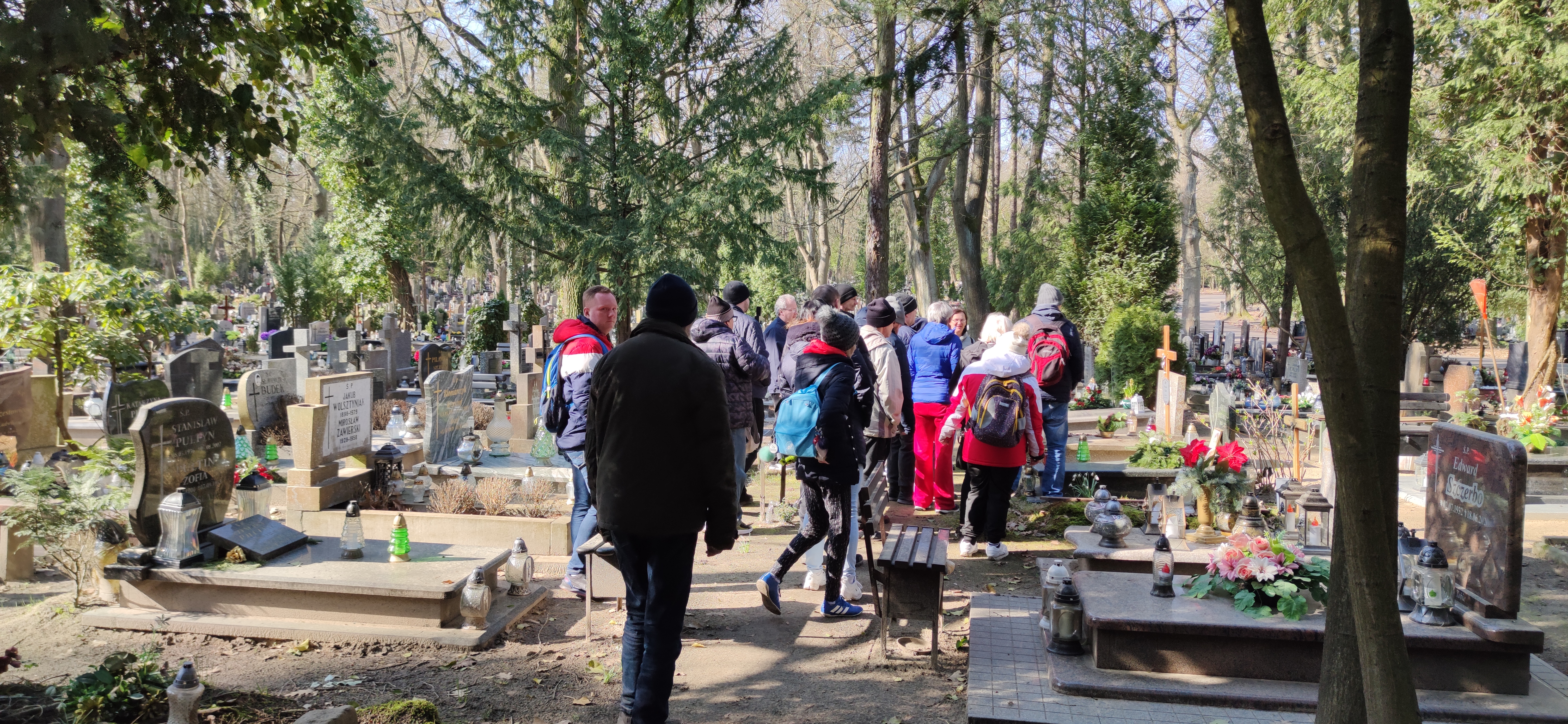 Grupa osób nad grobem.