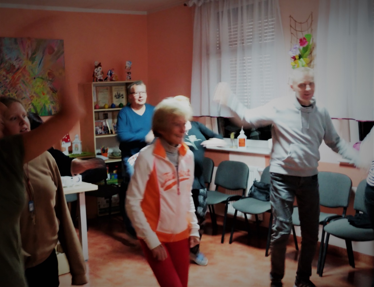 Trzy osoby tańczą w sali.