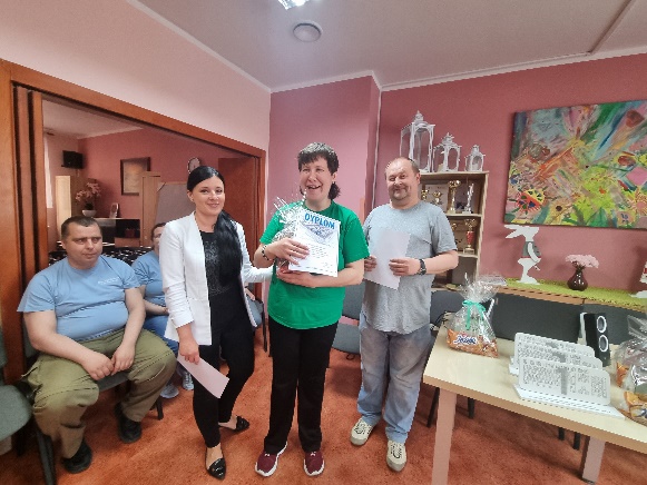 Kobiety i mężczyźni stoją patrząc w obiektyw aparatu fotograficznego.