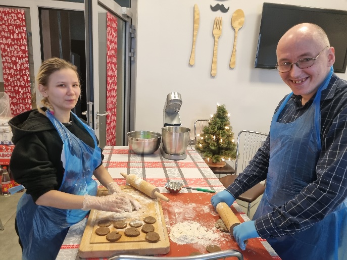 Kobieta i mężczyzna wałkują ciasto.